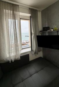 a room with a window with a view of the ocean at Lili's Sea View in Budva +9 photos