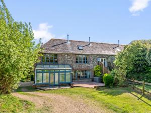an old stone house with a greenhouse in front of it at Chantry in Kingsbridge +11 photos