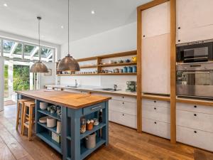 a kitchen with a blue island in the middle at Chantry in Kingsbridge