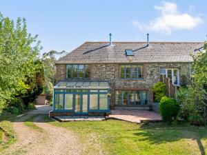 an old stone house with a blue window at Chantry in Kingsbridge