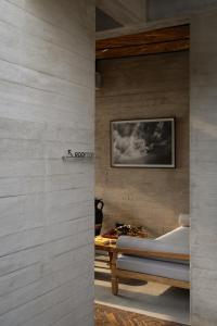 a bedroom with a bed and a table at Orama Bali in Uluwatu