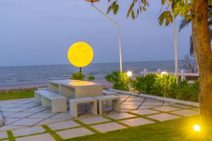 a table and a bench on the beach at Pailay Beachfront Villa Cha-Am in Ban Bang Ket +119 photos