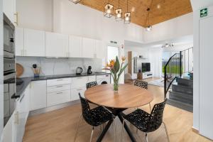 a kitchen and dining room with a wooden table and chairs at Exceptional stone character house Chalet Prazeres in Prazeres