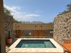 a swimming pool in front of a building at Perla Roca Hotel Boutique - Beach Front in Santa Marta