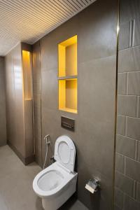 a bathroom with a white toilet in a room at Shri krishna paradise in Panvel