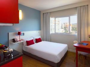 a hotel room with a bed and a window at Mercure Jundiai Shopping in Jundiaí +136 photos