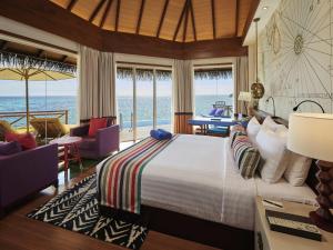 a bedroom with a bed and a view of the ocean at Mercure Maldives Kooddoo - Adults-Only Escape in Maamendhoo +111 photos