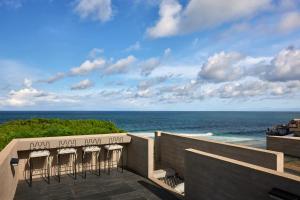 a view of the ocean from the balcony of a resort at Orama Bali in Uluwatu