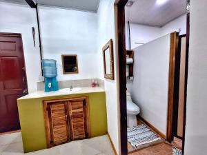 a bathroom with a sink and a toilet in it at Ocean Breeze Beach Front Apartment with AC in Puerto Viejo