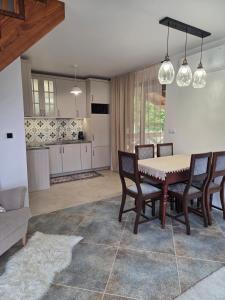 a kitchen and dining room with a table and chairs at Jagodowa Czulnia in Zwierzyń