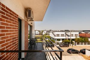 a balcony with a view of a parking lot at Premium Tulip Aparthotel close to Airport & Therme in Tunari