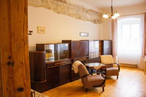 a living room with a table and chairs at Zámek Dobrohoř in Dobrohoř