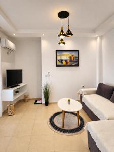 a living room with a couch and a table at Viola Apartments 2 Min to Beach in Vlorë