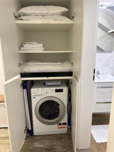 a laundry room with a washer and dryer at The View Apartment Bușteni in Buşteni