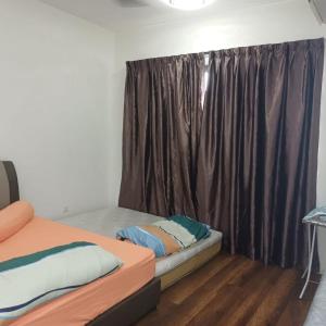 a bedroom with two beds and a window with brown curtains at Sunway Onsen Apartment Tambun by ELK Homestay in Tambun +13 photos