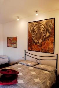 a bedroom with a painting of a tiger on the wall at La Collina D'Oro in Cernobbio