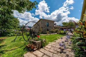 a garden with a swing set and flowers at Casa de Alderete in Valença
