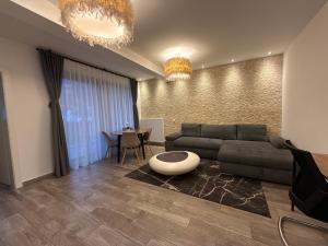 a living room with a couch and a table at The View Apartment Bușteni in Buşteni