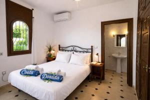 a bedroom with a large bed and a sink at villa PLAYA RUSTICAL in Miami Platja +17 photos