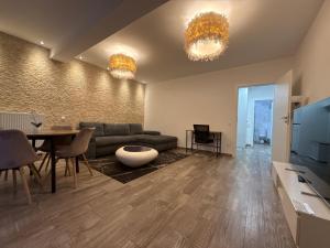a living room with a couch and a table at The View Apartment Bușteni in Buşteni