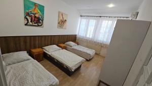 a room with three beds in a room at Hradna 9a in Nové Zámky