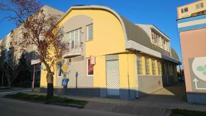 a yellow and white building on the side of a street at Hradna 9a in Nové Zámky