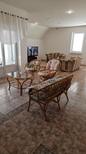 a living room with chairs and a table and a couch at Hradna 9a in Nové Zámky