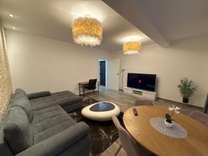 a living room with a couch and a table at The View Apartment Bușteni in Buşteni