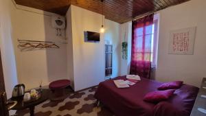 a bedroom with a bed and a table and a window at Villa Sunrise in Lucca