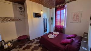 a bedroom with a purple bed and a window at Villa Sunrise in Lucca