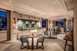 a restaurant with tables and chairs and a bar at Hotel Mediterraneo Sorrento in Sant'Agnello