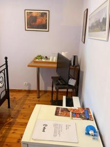 a room with a desk with a computer on a table at Philoxenia in Spata