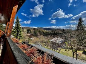 a view from the porch of a house with a view of a forest at Chata Na Pasekách in Rajnochovice