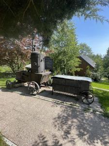an old train with a cart on the side of the road at Chata Na Pasekách in Rajnochovice +4 photos