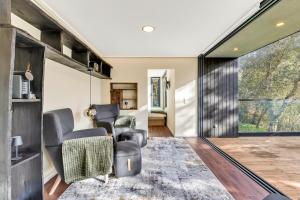 a living room with chairs and a sliding glass door at Zaire Lodge in Mira +40 photos