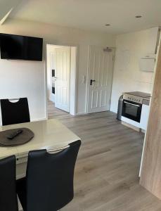 a living room with a kitchen and a table at Seaside-Amrum-14 in Norddorf