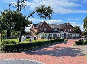 a large red brick building with people walking around it at Seaside-Amrum-14 in Norddorf