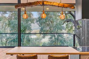a kitchen with a table and a large window at Zaire Lodge in Mira