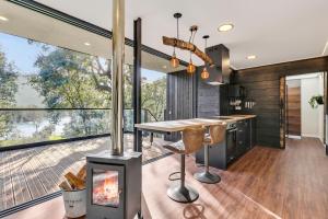 a kitchen with a fireplace and a table and chairs at Zaire Lodge in Mira