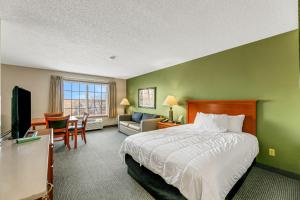 a bedroom with a bed and a living room at Country Inn Walker in Walker +80 photos