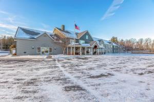 a large building with snow on the ground at Country Inn Walker in Walker