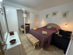 a bedroom with a large bed and a mirror at Primavera in Costa Del Silencio