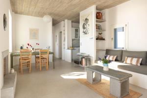 a living room with a couch and a table at Villa Petra in Andros
