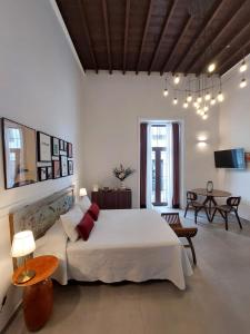 a bedroom with a large bed and a living room at Apartamentos La Florida in Arrecife