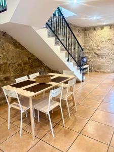 a dining room with a table and chairs and stairs at LS Alojamiento Turístico in Arcade