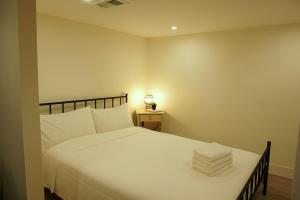 a bedroom with a large white bed and a lamp at ION House - Near Shopping Kennedy Station Easy Transit Downtown in Toronto +5 photos