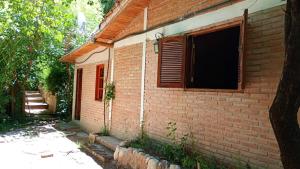 a brick house with a window on the side of it at Aloe in Mina Clavero