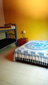 a bedroom with a bed and a yellow wall at Aloe in Mina Clavero