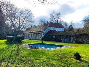 an old house with a swimming pool in the yard at Château de Courcelles in Équevilley +20 photos