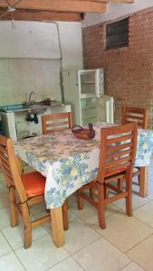 a kitchen with a table and chairs with a table and a kitchen at Aloe in Mina Clavero